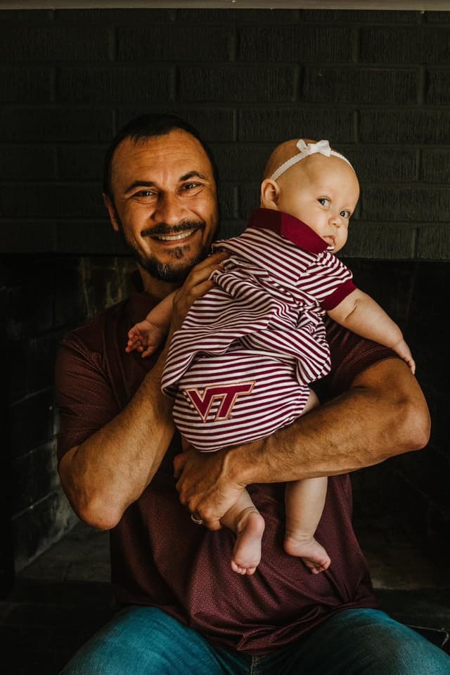 Chris Womble, founder of IT Mushroom, holding his child